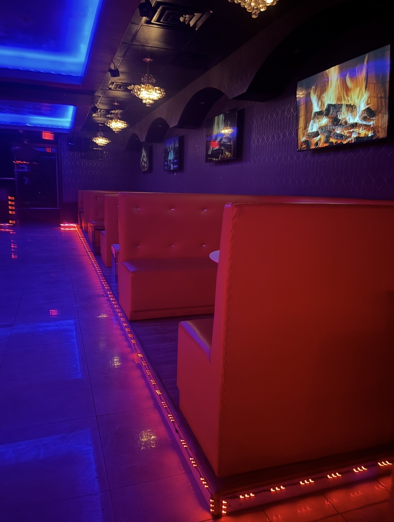 Selam Café Interior with Red Booths and Blue Ceiling Light